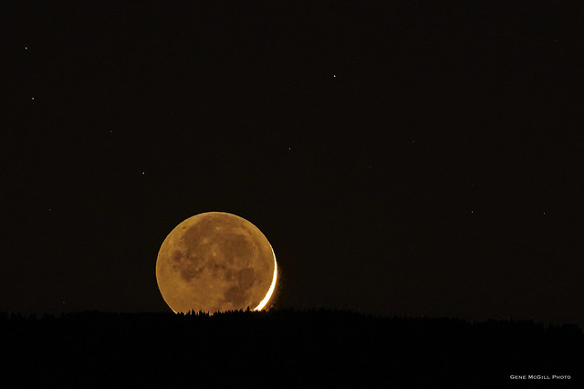 Crescent moon setting over Grand Mesa