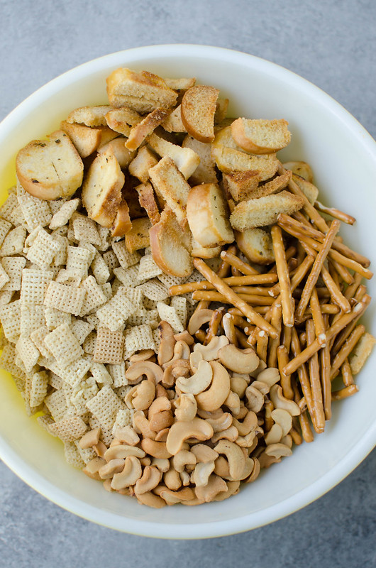 Dill Pickle Chex Mix - my alltime favorite Chex Mix! Chex cereal, bagel chips, pretzel sticks, and cashews coated in a buttery dill pickle and ranch seasoning and baked until crispy and delicious. 