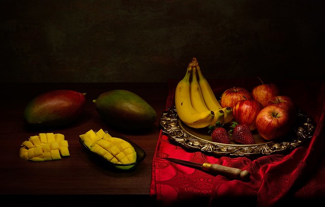 Still life with mangoes, apples, bananas and strawberries