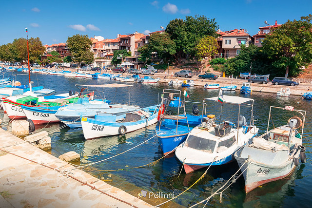 sozopol, bulgaria - SEP 09, 2019: fishing boats in port on a sunny day. embankment on the background of a scenery