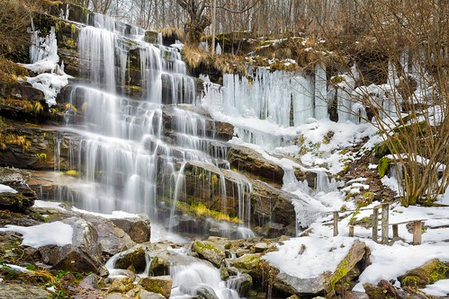 tupavica waterfall frozen icicles ice water fall cascade rock cliff red wooden bench stara planina serbia dojkinci old mountain forest scenic long exposure silky blurred motion dreamy beautiful winter spring snow