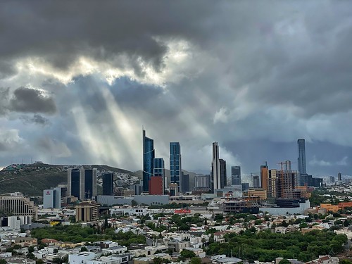 clouds rays sun skyscrapers weather city mexico monterrey spgg