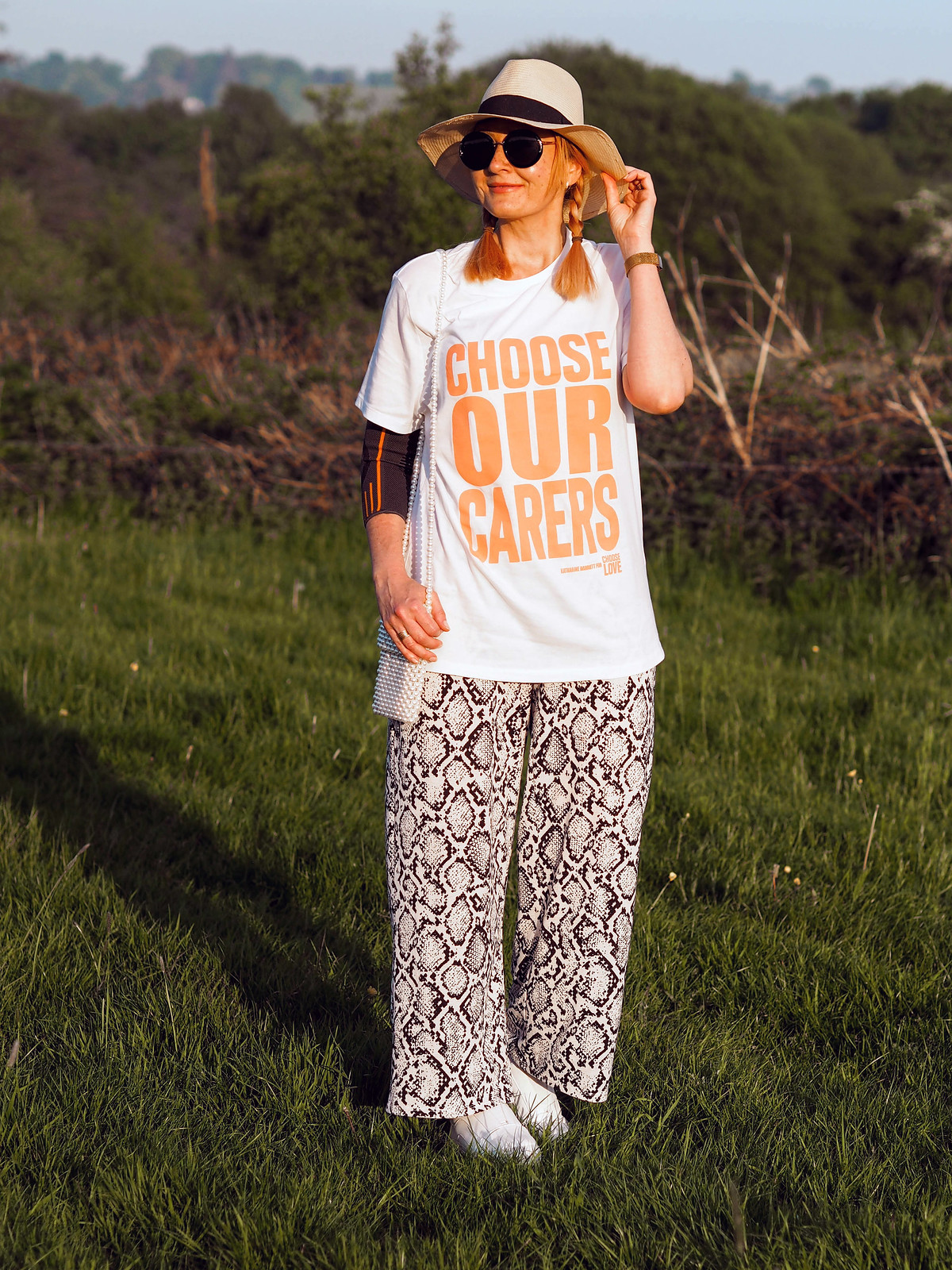 Styling the Charity 'Choose Our Carers' T-Shirt (With snake print wide leg pants and a straw hat) | Not Dressed As Lamb, over 40 style