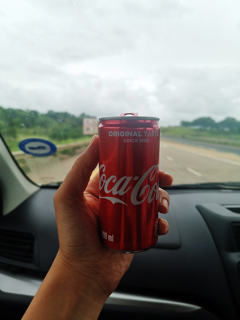 Can of Coca-cola inside vehicle