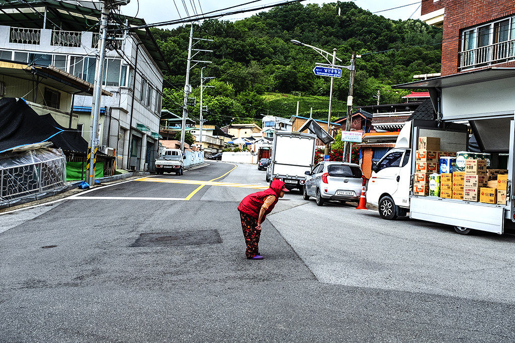 Old woman taking a rest while crossing the street--Gimcheon