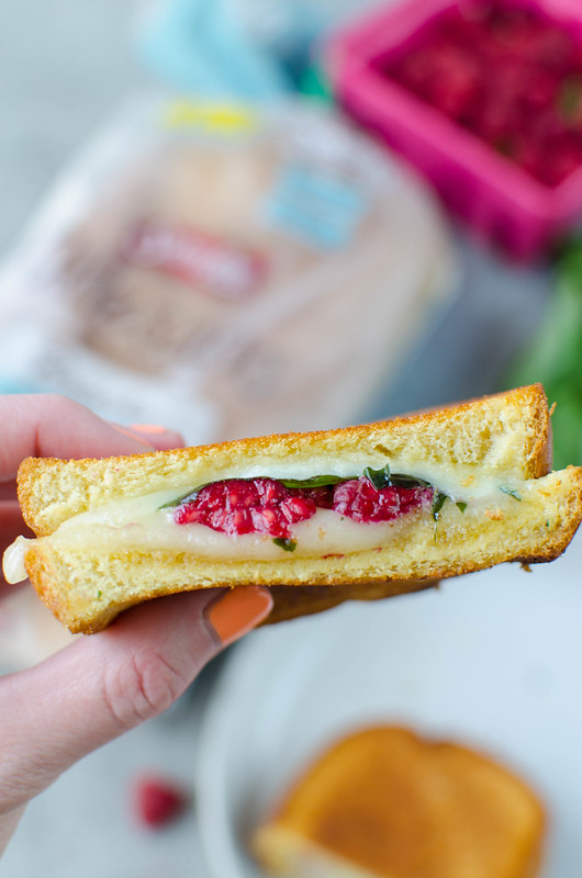 Raspberry, Basil, and Brie Grilled Cheese - creamy brie cheese with fresh raspberries and basil and a drizzle of honey! On brioche bread and grilled until the cheese is melty and delicious. 