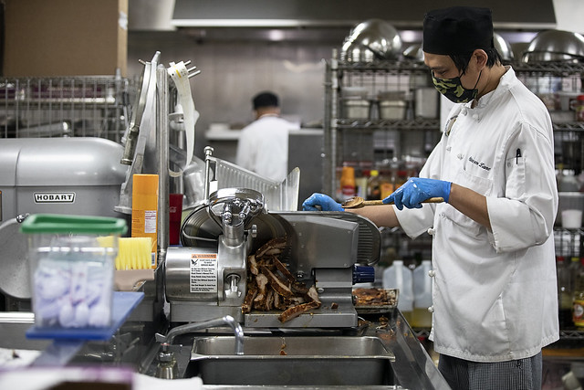 A kitchen staff worker preparing food