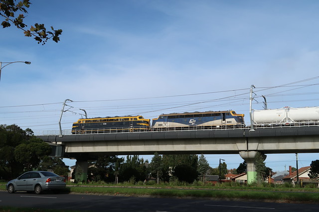 B74+B80 head east along the elevated 'sky rail' section at Carnegie with #9571 Melbourne to Dandenong South cement train.