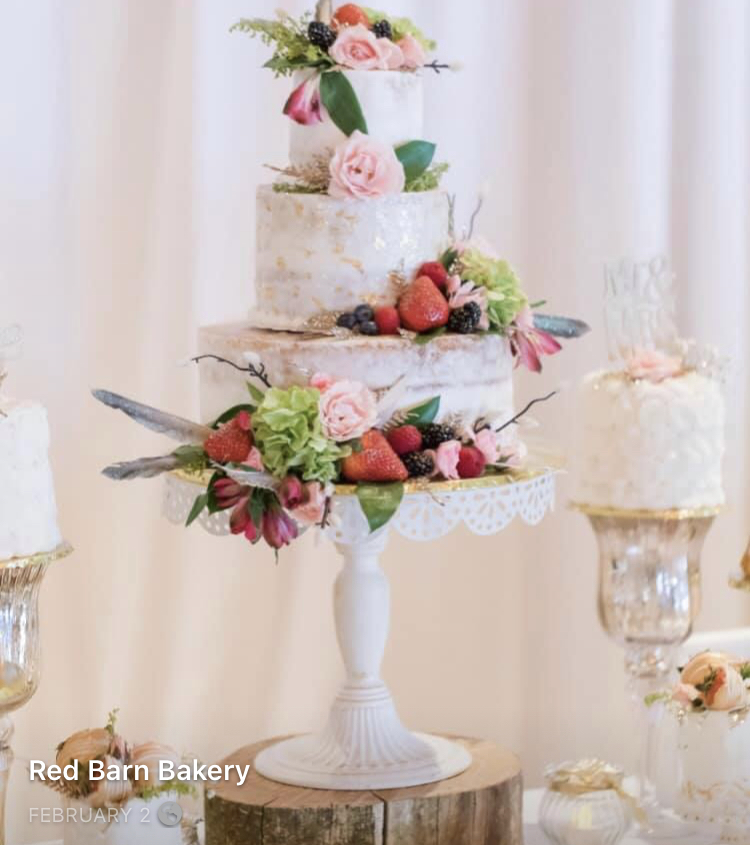 I created this cake for a Bridal fair. The center cake features 24K Pure Gold Leaf. Additionally, the cake is adorned with fruit, flowers and feathers. By Michelle Jacobsen of Red Barn Bakery