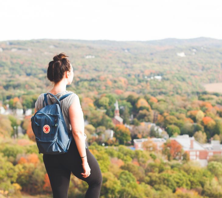 woman overlooking town hiking
