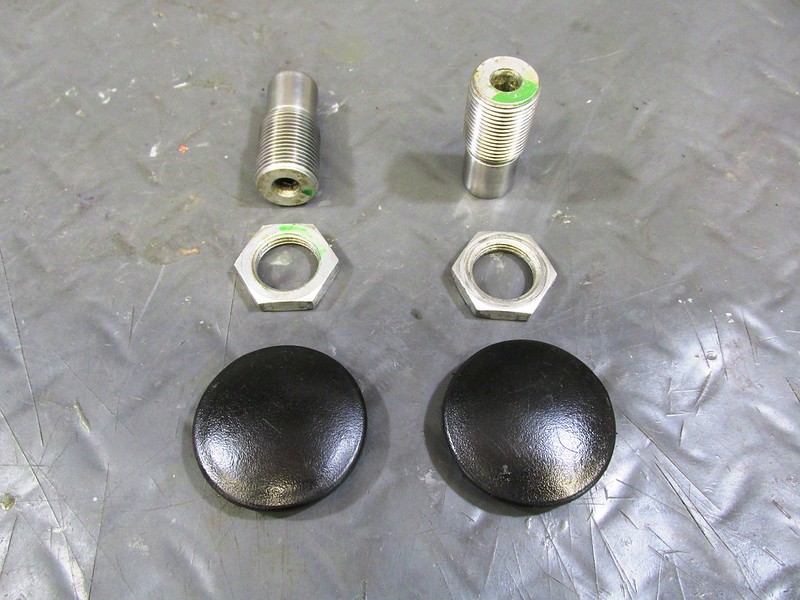 Swing Arm Mounting Hardware Detail: (Top)-Pivot Bolts; (Middle) Lock Nuts; (Bottom) Plastic Dust Caps