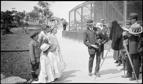 Camera man with orang-outang, Taronga Zoo 1917