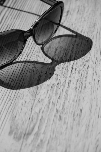 Black and white Sunglasses isolated on a wooden background