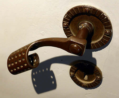 bronze door handle and its shadow in a Copenhagen Church gallery, Denmark