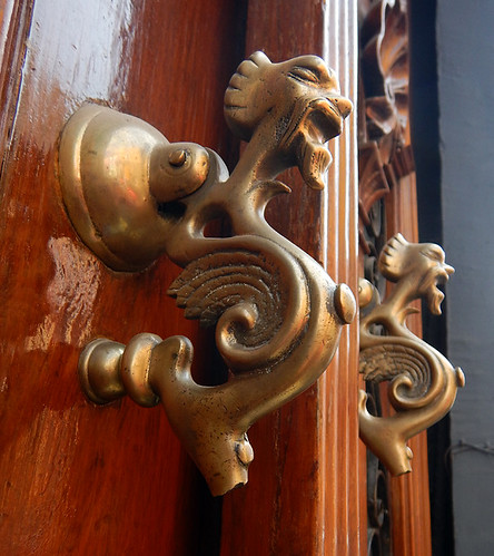 Brass door handles in the form of two quirky guys in Puebla, Mexico