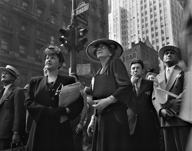 In this Poignant Hour: Crowds of onlookers read news of the Allied invasion of Normandy on an electric marguee in Times Square on D-Day June 6, 1944.
