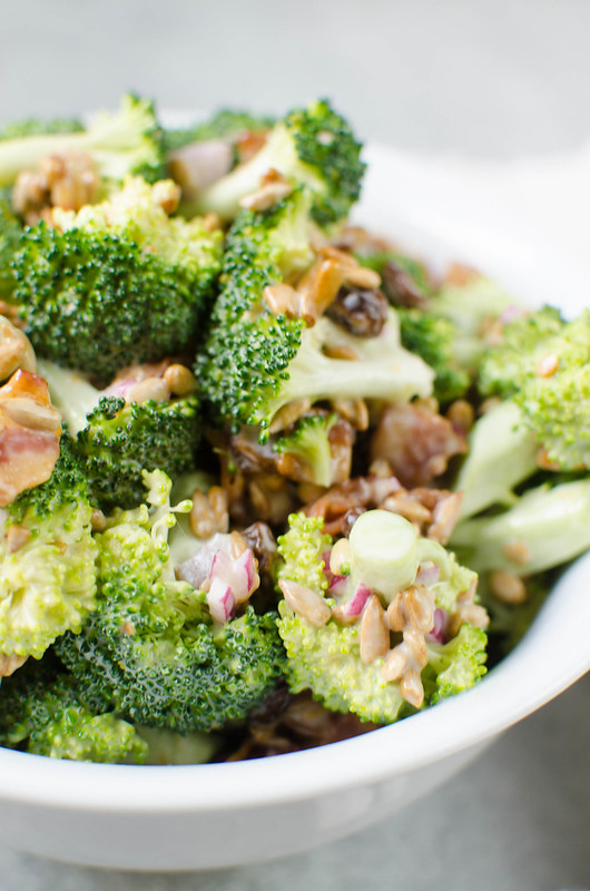 Broccoli Salad - my favorite summer side dish! Fresh broccoli, red onion, raisins, bacon, and sunflower seeds in a sweet and tangy dressing. 