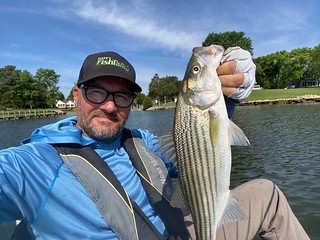Eric Packard holding up a nice striped bass