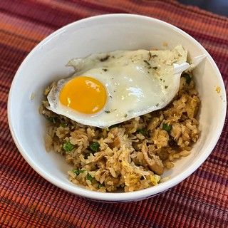#kvpkitchen Adobe fried rice silog for lunch. I had pork adobo chilling in the freezer after one of my parents’ visits. Warmed everything up. Then I fried rice with sesame oil, greens onions and peas. Mixed adobo and rice in the wok. Added a fried egg wit | by queenkv
