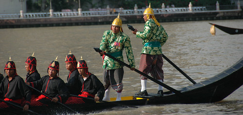 Boatmen, in traditional costume, rowing the King's Barges (long boats) in a rehearsal of the processions in Bangkok, Thailand