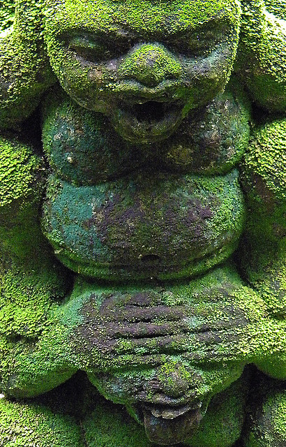 Mossy sculpture of the three 'no evil' monkeys in the Singapore Botanical Garden