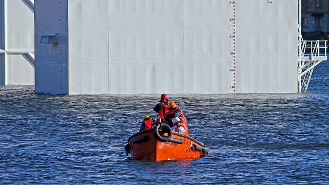 Some of the crew from on board the heavy load carrier Zhen Hua 33 in Stockholm, circling the ship in a MOB boat