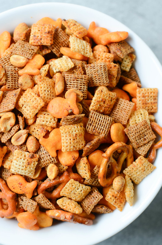 Cheesy Taco Chex Mix - Chex cereal, Goldfish crackers, pretzels, and peanuts tossed in a delicious taco seasoning and baked until crunchy and delicious!