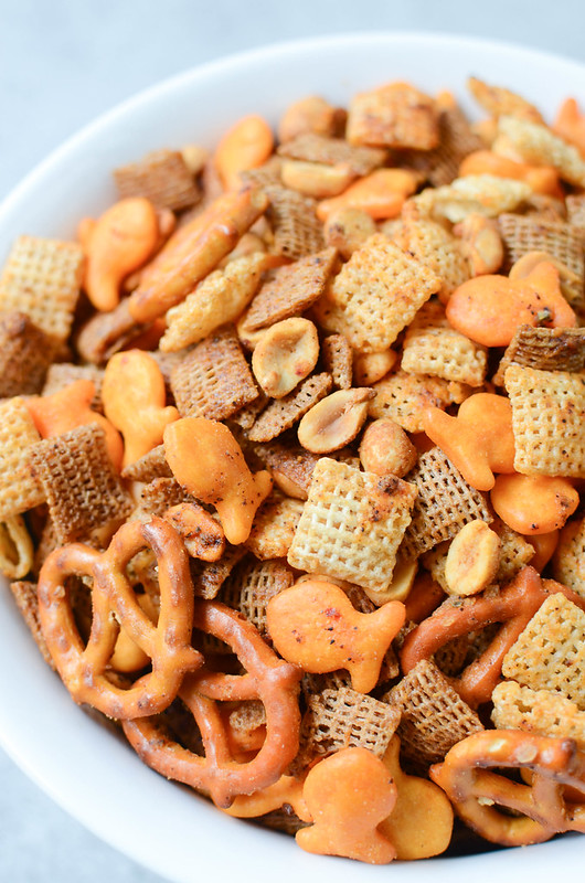 Cheesy Taco Chex Mix - Chex cereal, Goldfish crackers, pretzels, and peanuts tossed in a delicious taco seasoning and baked until crunchy and delicious!