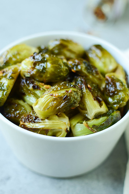 Spicy Honey Roasted Brussels Sprouts - fresh brussels sprouts tossed in a sweet and spicy sauce and roasted until crispy and delicious. 