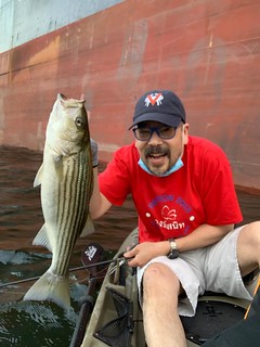 Photo of man with striped bass