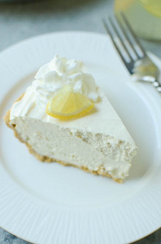 Frozen Lemonade Pie - only 4 ingredients and no bake! Graham cracker crust with a sweet creamy lemonade filling. The perfect summer dessert!