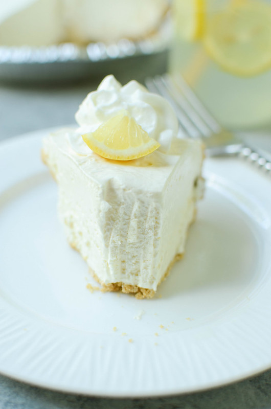 Frozen Lemonade Pie - only 4 ingredients and no bake! Graham cracker crust with a sweet creamy lemonade filling. The perfect summer dessert!