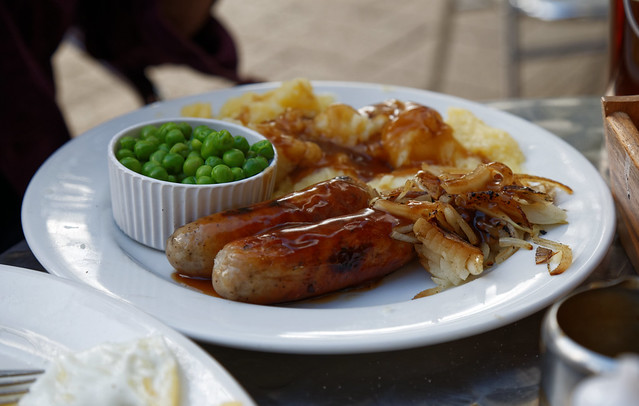 A plate of sausage mash onions and peas Epping Essex, England