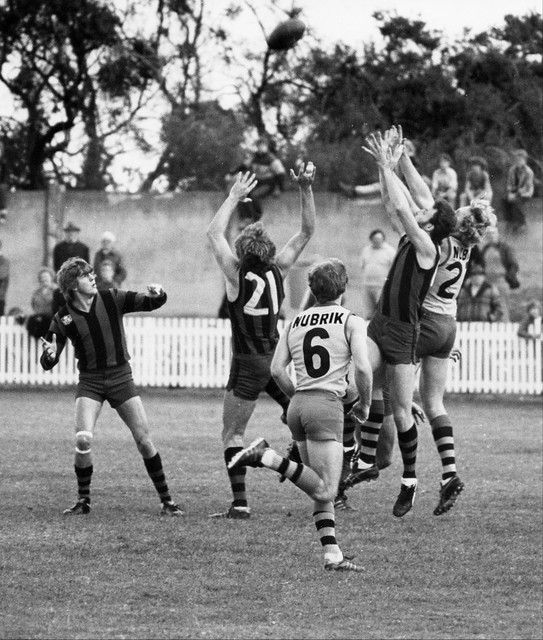 VFA: Waverley vs Sandringham at the Sandringham Beach Road Ground. Waverley players in dark guernseys are, from left to right: Ken McCormack, Dave McEwin (number 21) and Geoff Clark.