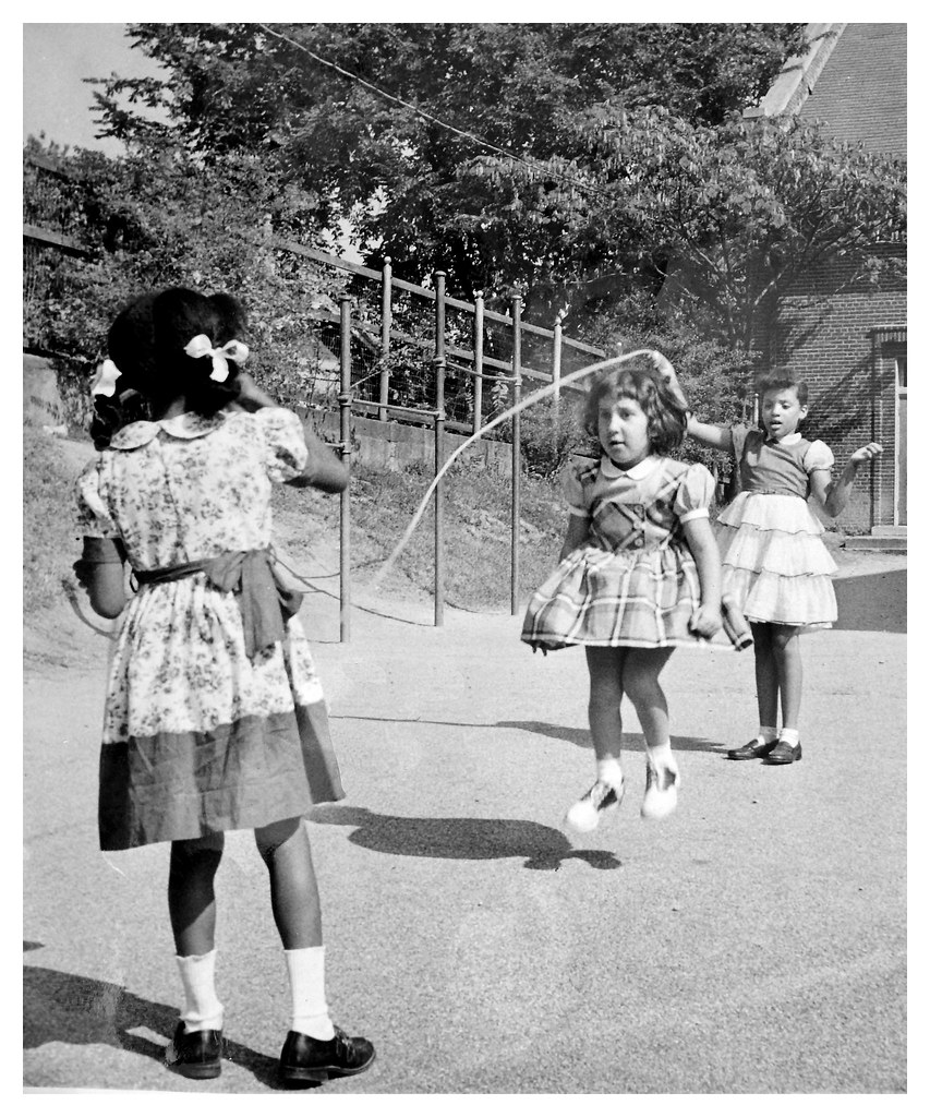 Black & white children play after integration: 1956