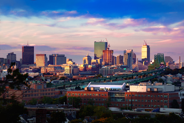 Boston city skyline with bridges and highways at dusk