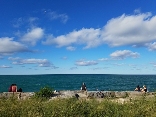 lake lakemichigan promontorypoint chicago water people sitting view bicycle rest clouds sky blue