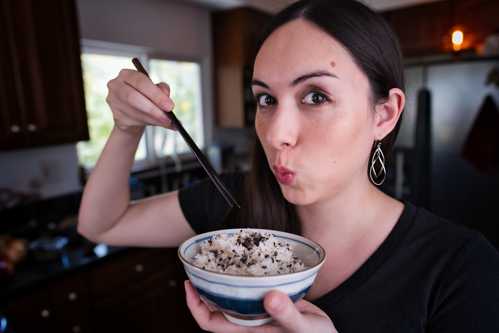 Allison holding a bowl of rice topped with furikake nori