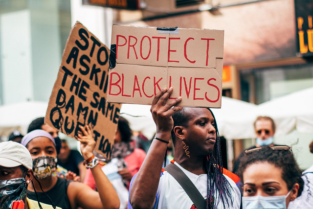 Black Lives Matter activist holding Protect Black Lives sign