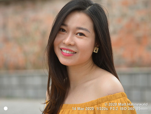 matthahnewaldphotography facingtheworld qualityphoto head shoulders face eyes teeth lipstick expression lookingatcamera longhair partinghair yellow offshoulder dress consensual emotional lifestyle love enjoyment happiness joy grace beauty fashion style virtue affection urban oriental cultural photoshoot model hanoi vietnam asia asian vietnamese adult person one female girl young woman primelens nikond610 nikkorafs85mmf18g 85mm street portrait closeup headshot threequarterview sidewaysglance outdoor naturallight colour color posingcamera smiling feminine beautiful attractive happy pretty lovely fabulous clarity sharpness
