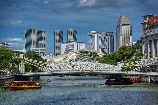 Singapore river with tourist bum boats, Cavenagh bridge and Esplanade Theaters by the Bay