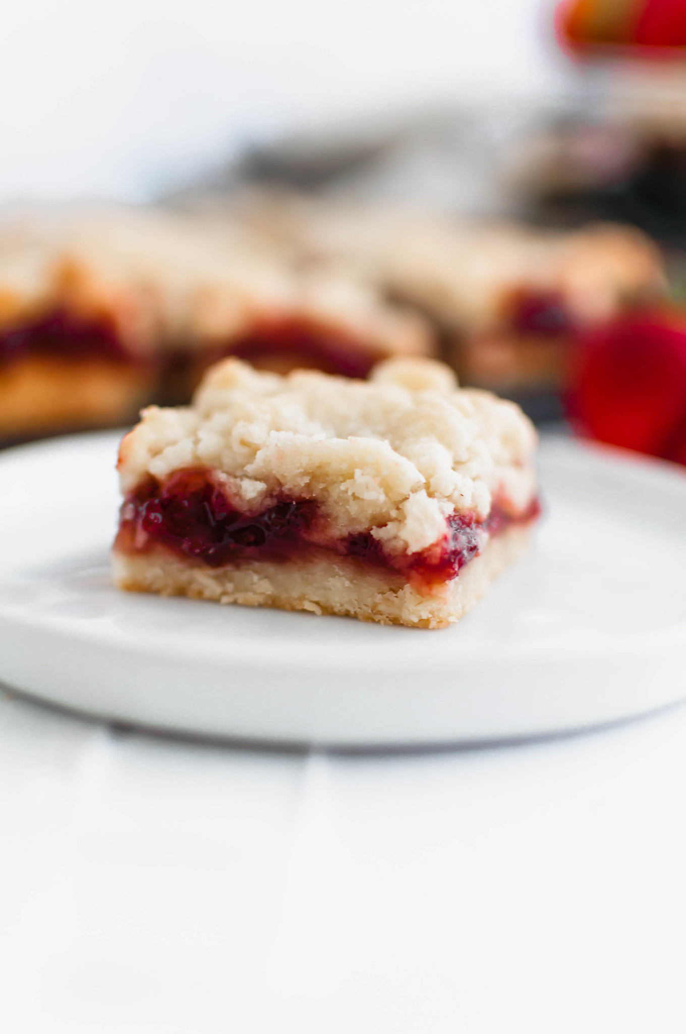 These Strawberry Crumb Bars are an amazing summer dessert. The simple shortbread crust also doubles as the crumble on top. Old-fashioned oats add a delicious chewy texture to the crust.