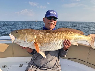 Photo of man holding a large red drum