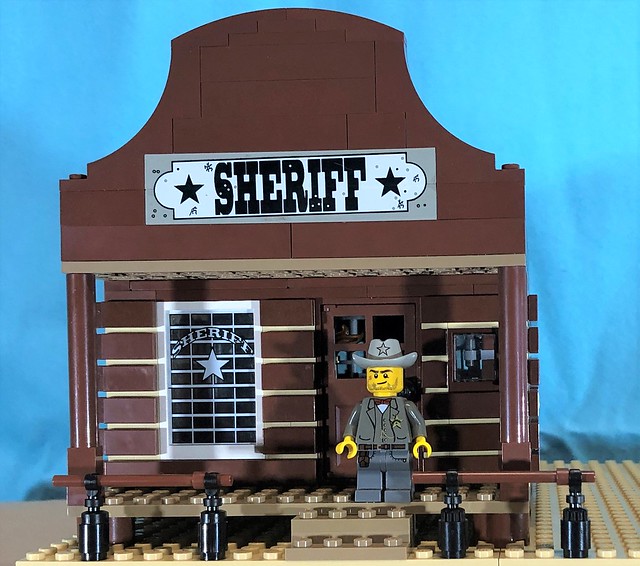 Sheriff Marcus now has a new Office. This office comes with a small desk, weapons rack, and a small jail cell where he currently has a bandit detained.