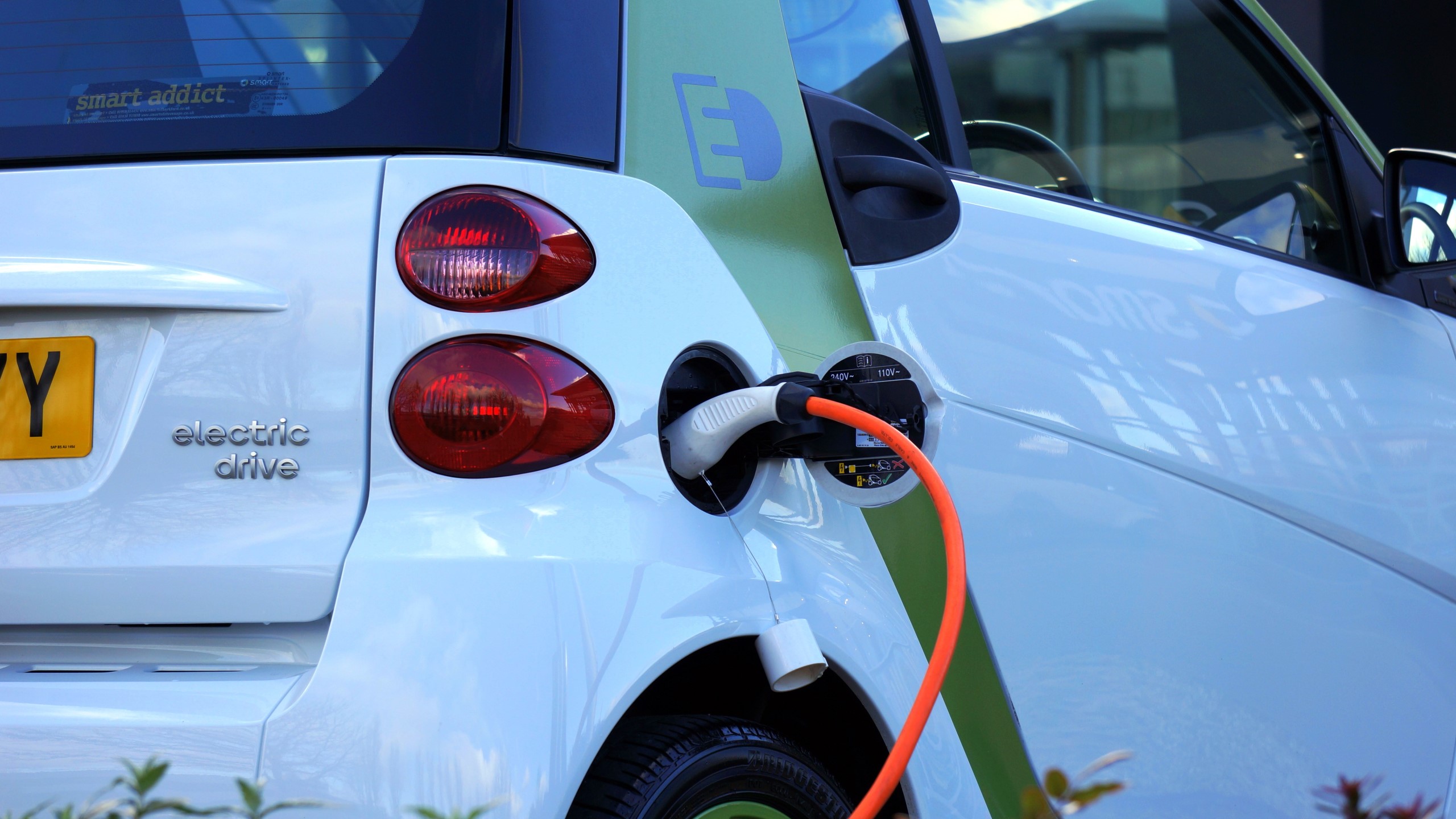 An electric car plugged in to charge