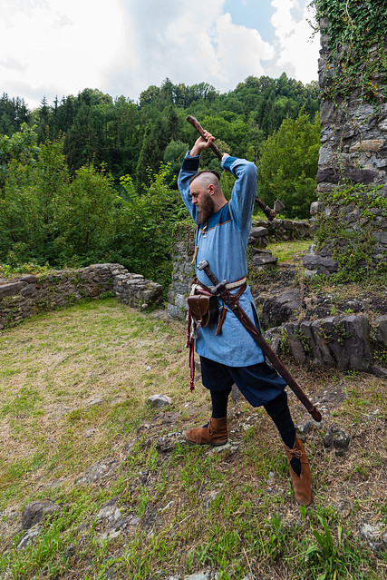 Viking warrior with thick beard brandishes an ax