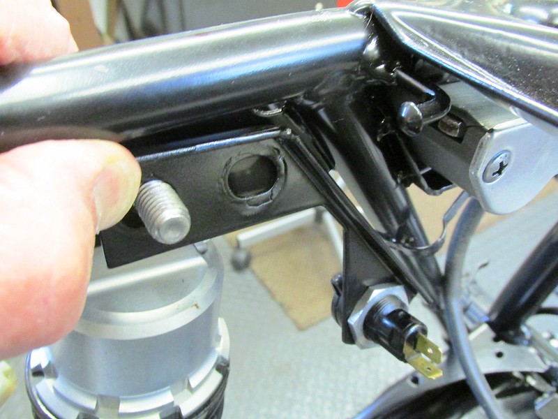 Auxiliary Bracket Mounts To Top Left Shock Bolt