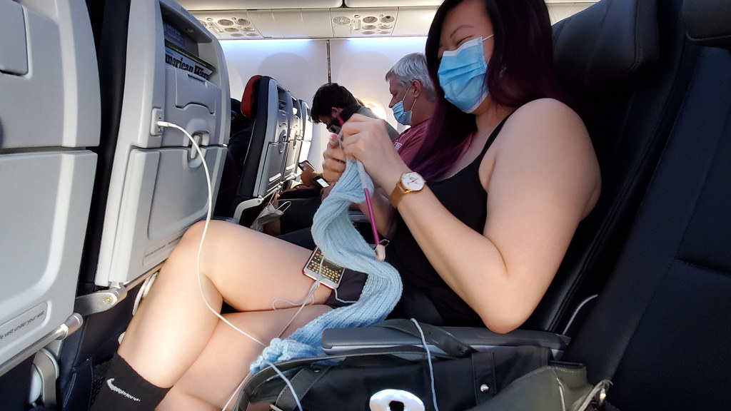 Monica knitting on a flight