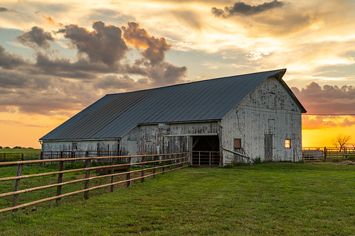 ranch barn farm fence sunset clouds golden goldenhour grass kansas blue gray country landscape sony ilce7rm3