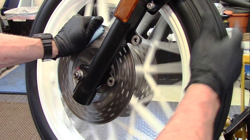 Rotate Wheel With Towel Sprayed With Brake Cleaner Wrapped Around The Disk
